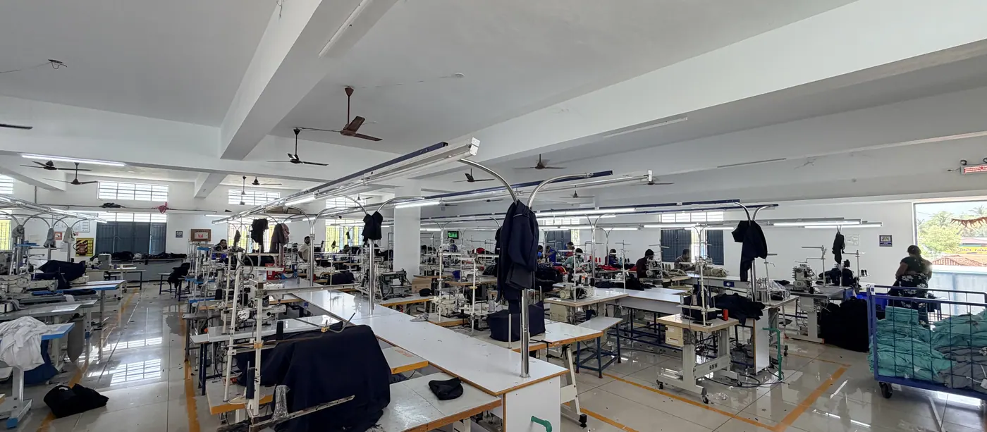 Sewing lines in production, garments stacked at each station