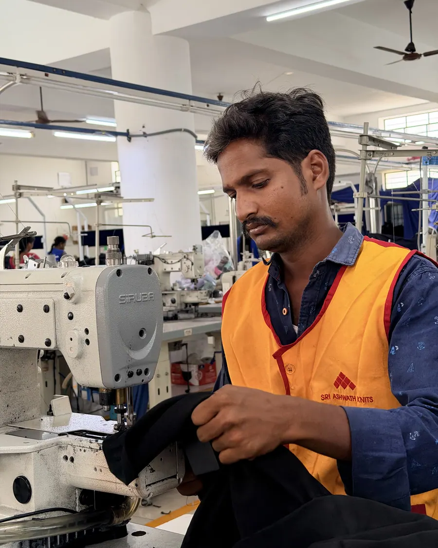 An operator at a single-needle machine on the stitching floor